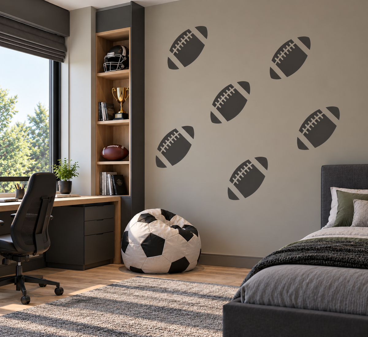 American Football Stencil in dark gray on a light gray bedroom wall beside a desk and football-themed decor.