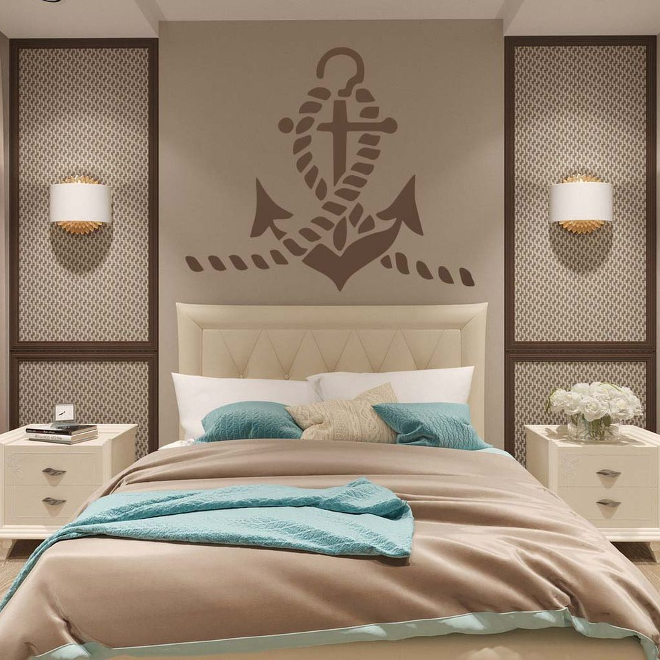 Anchor Stencil in taupe on a beige wall above the bed in an elegant bedroom with turquoise accents.
