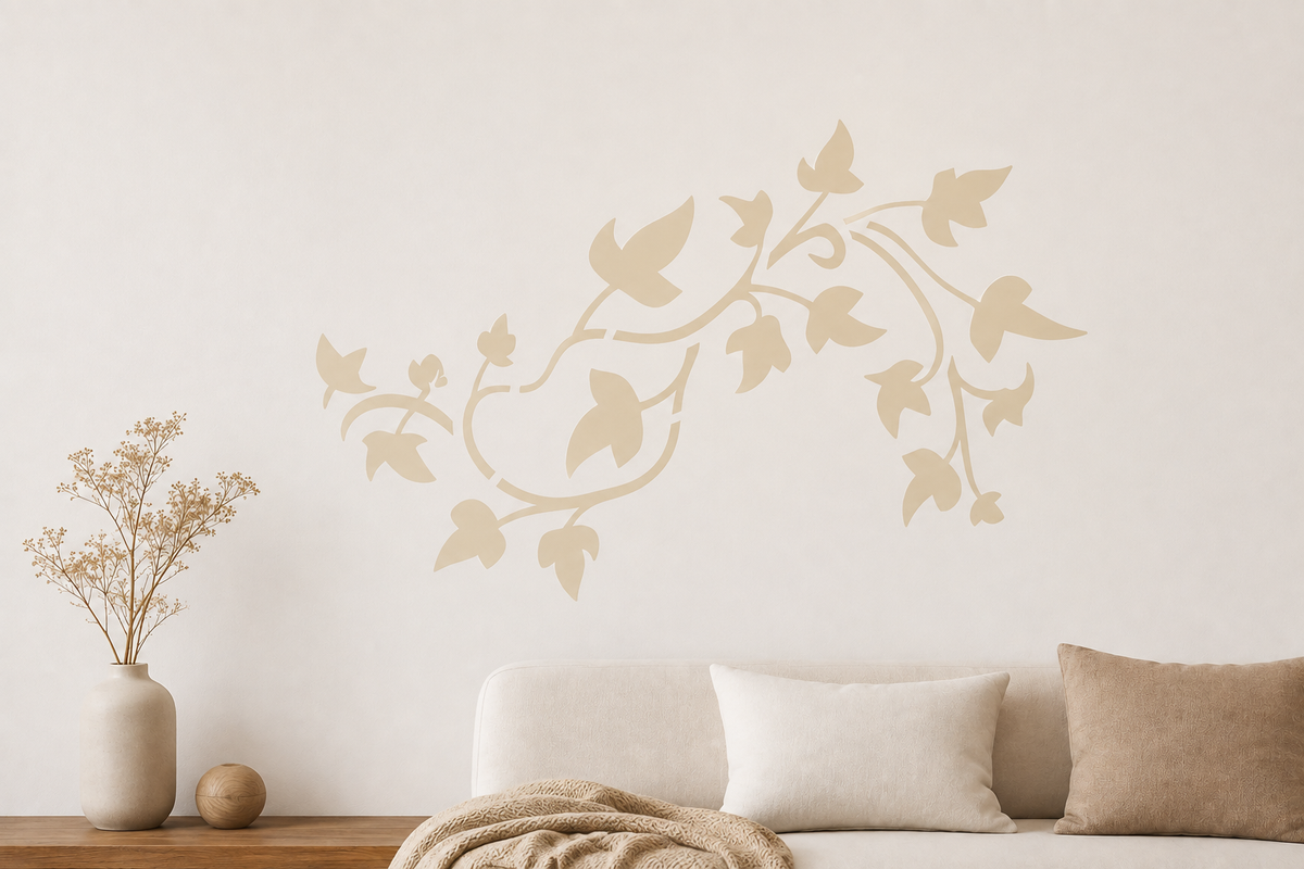 Neutral living room with a soft beige ivy vine stencil painted on a warm white wall above a cream sofa.