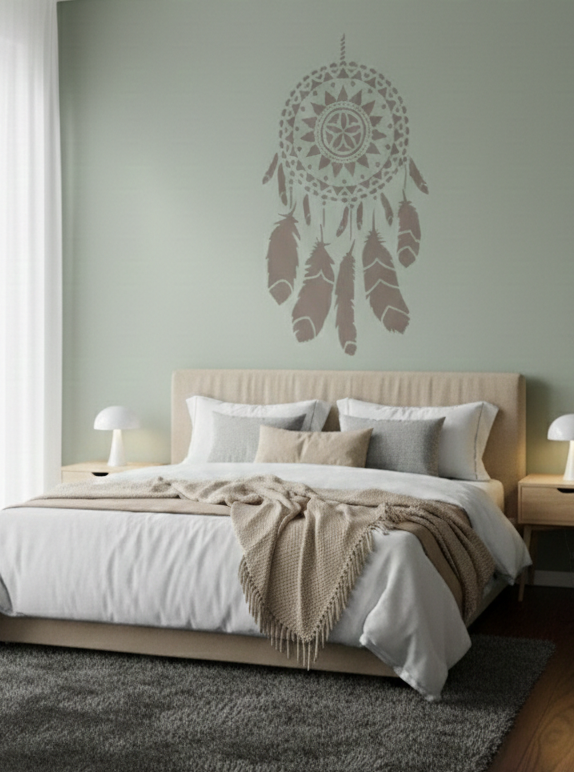 Boho dreamcatcher wall stencil above bed on a green accent wall in a modern bedroom