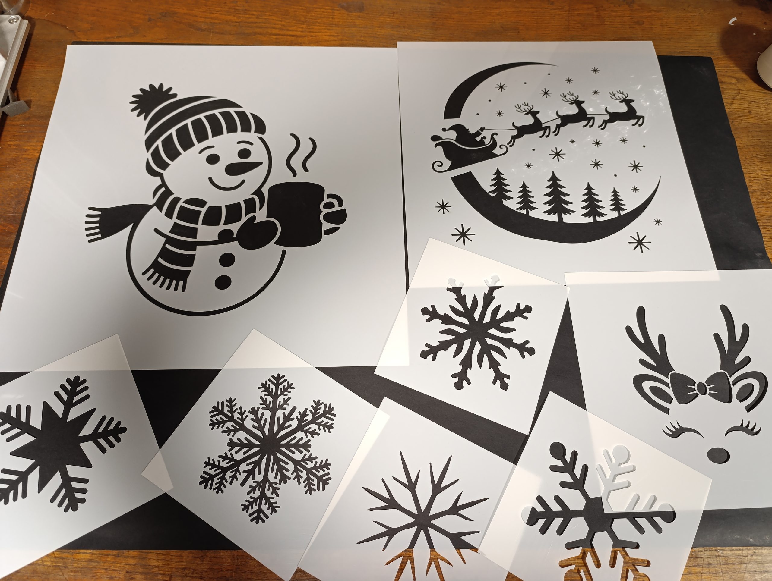 Christmas stencil set with snowflakes, snowman, reindeer and Santa sleigh for window decorating