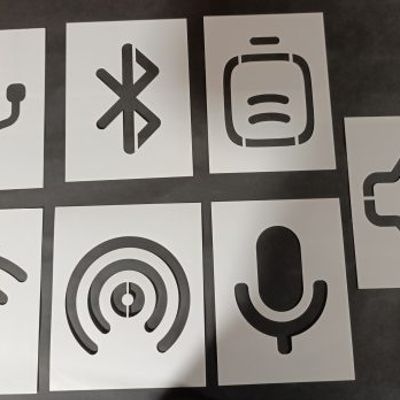 Set of classroom stencils with technology symbols including USB, Bluetooth, battery, volume, WiFi, podcast, and microphone icons