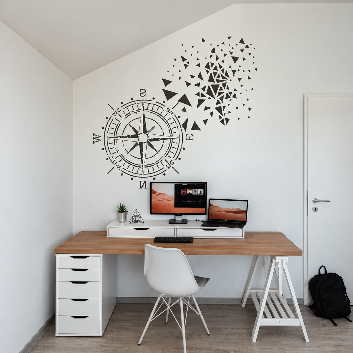 Black Compass Rose Stencil with geometric triangle accents on a white wall above a wooden desk in a minimalist home office.