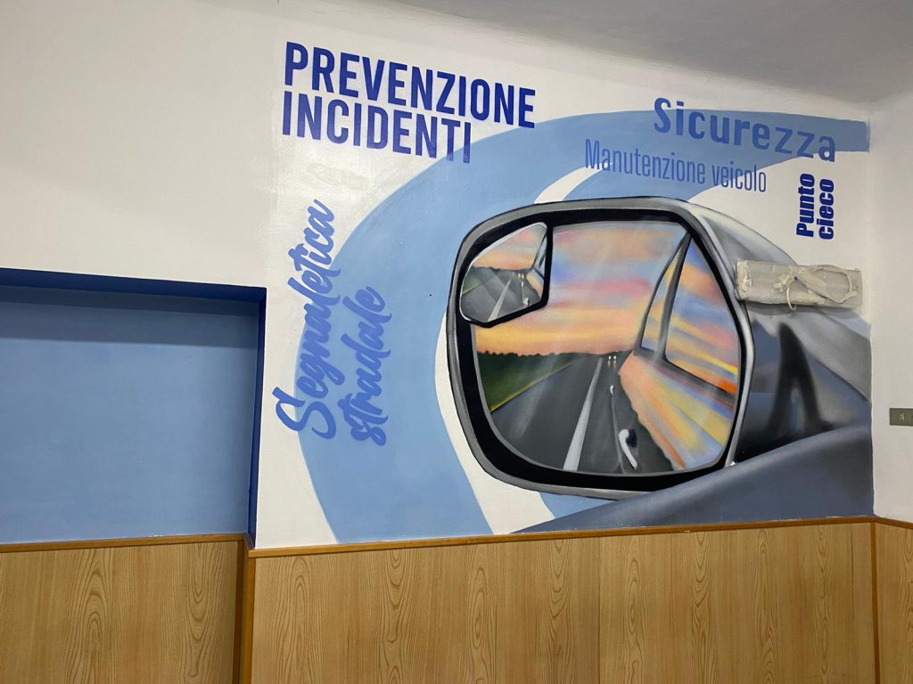 alt="Close-up of a custom stencil logo painted on a wall for a non-profit association"