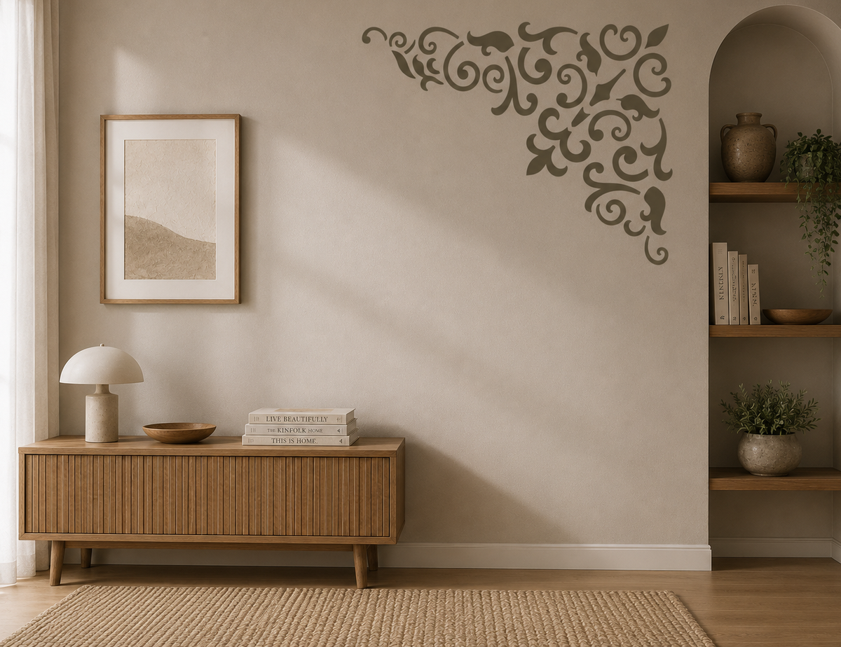 Decorative corner stencil with an elegant vintage scroll and flourish pattern painted on a neutral interior wall.