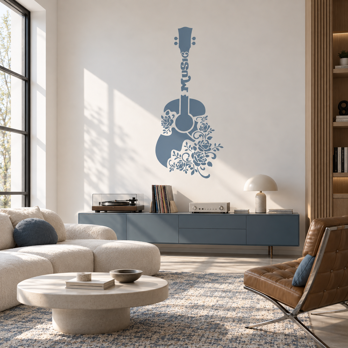 Dusty blue floral guitar stencil with intricate rose patterns on a white wall in a modern living room with a record player and blue furniture.