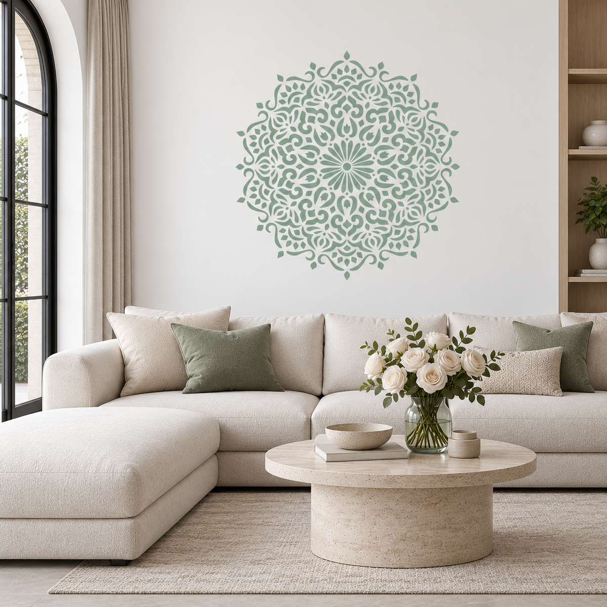 Floral Mandala Wall Stencil in sage green above a cream sofa with green cushions in a bright living room.
