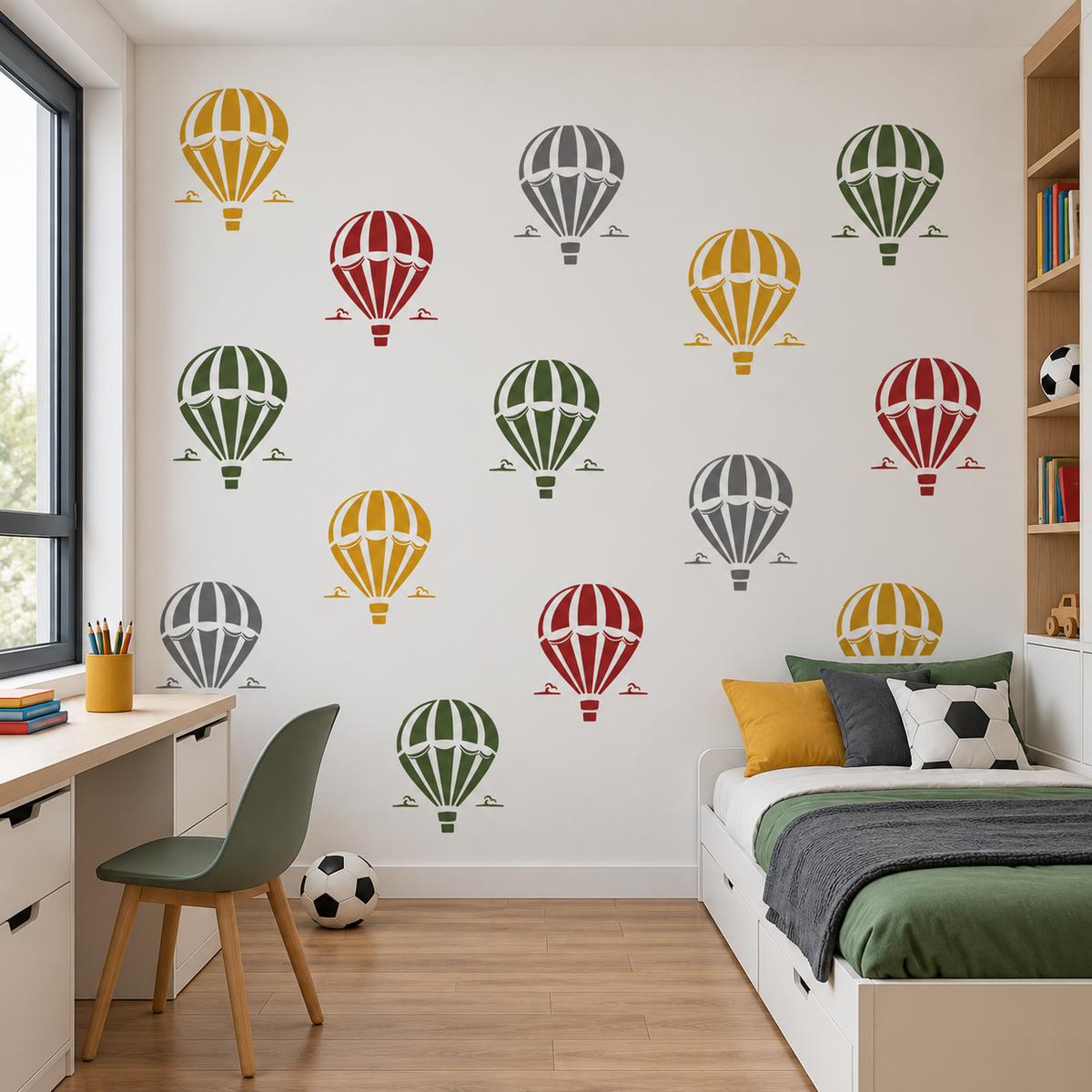 Hot Air Balloon Stencil pattern in yellow, red, green and gray on a white wall in a colorful kids bedroom with a desk and bed.