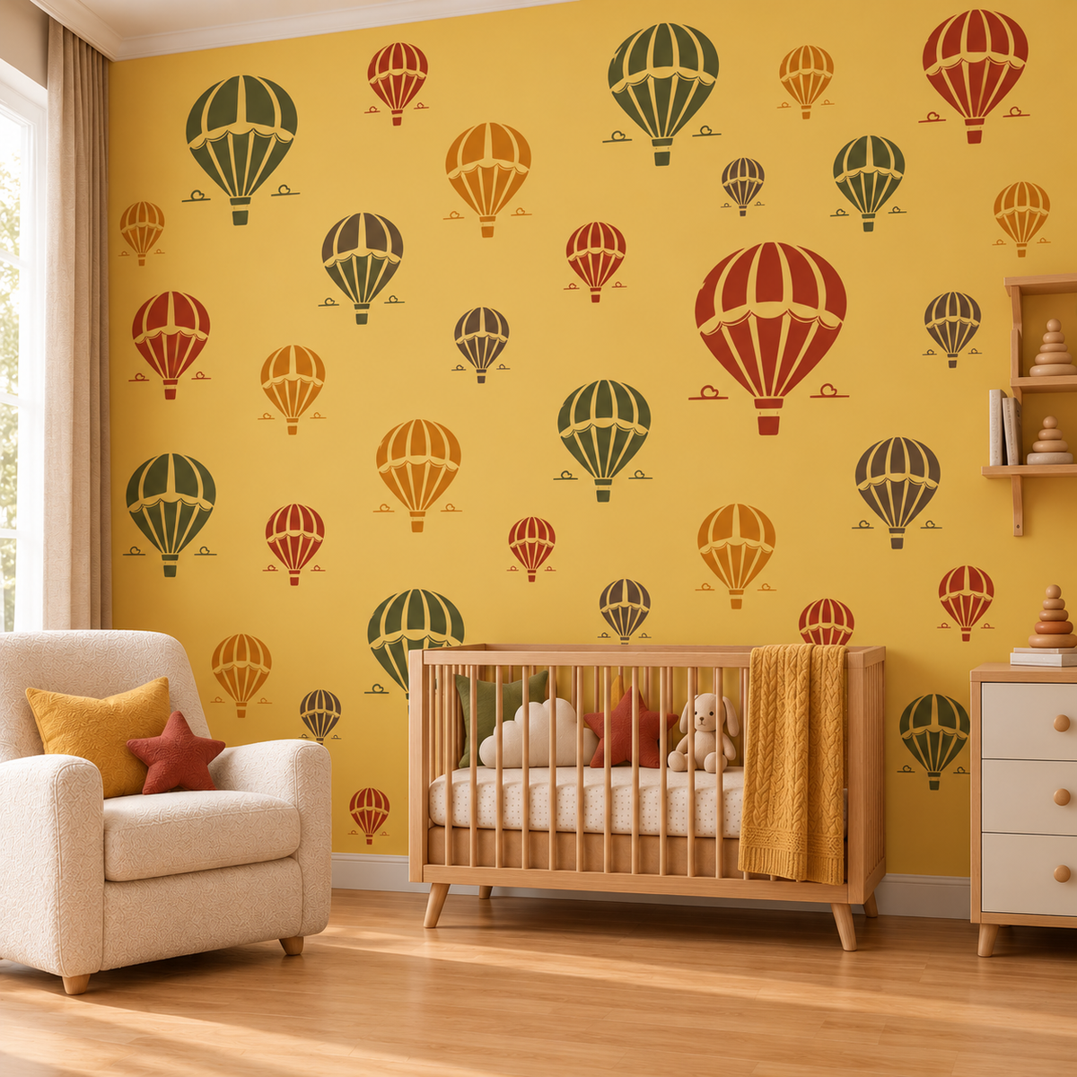 Hot Air Balloon Stencil pattern in red, green, orange and gray on a mustard yellow nursery wall behind a wooden baby crib.