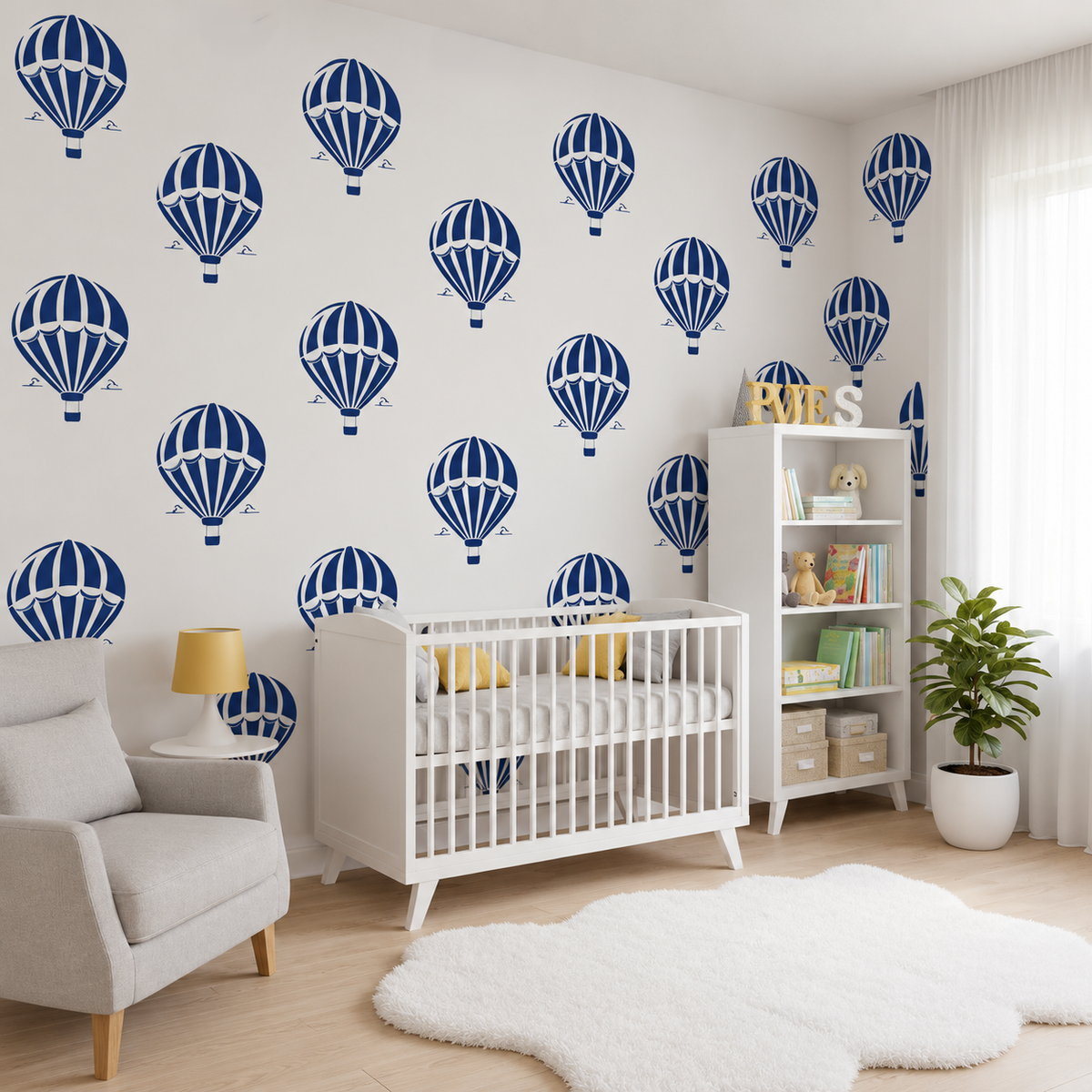 Repeating Hot Air Balloon Stencil pattern in navy blue on white nursery walls behind a baby crib and bookshelf.