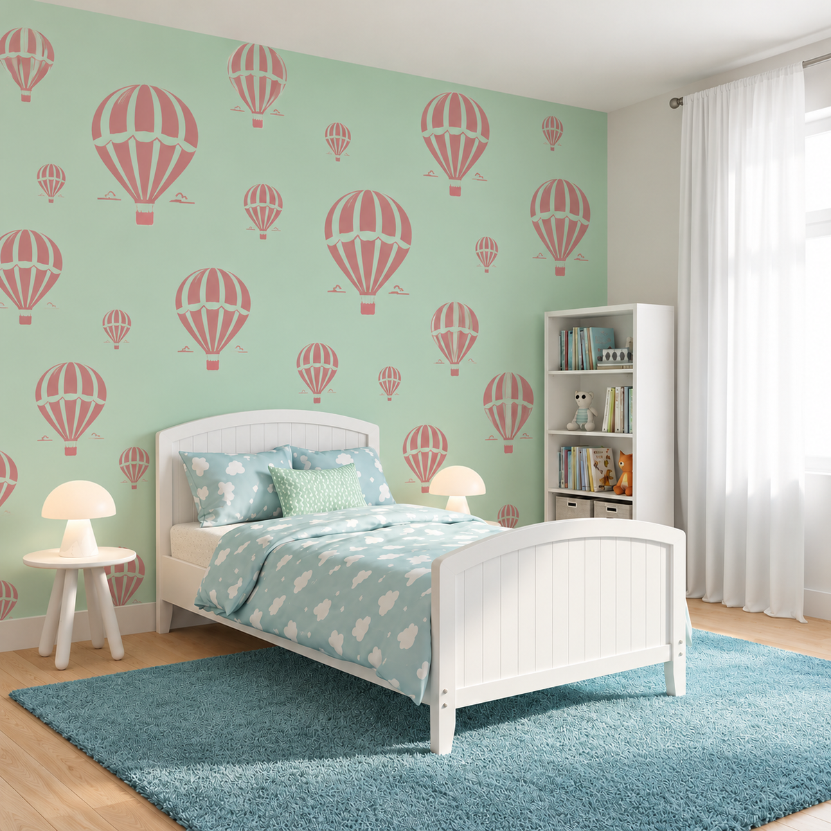 Hot Air Balloon Stencil pattern in soft pink on a mint green wall above a white bed in a bright girls bedroom.