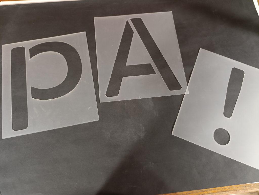 Letter stencils with mixed symbols, featuring cut-out alphabet characters, numbers, and special signs for versatile marking and crafting use.