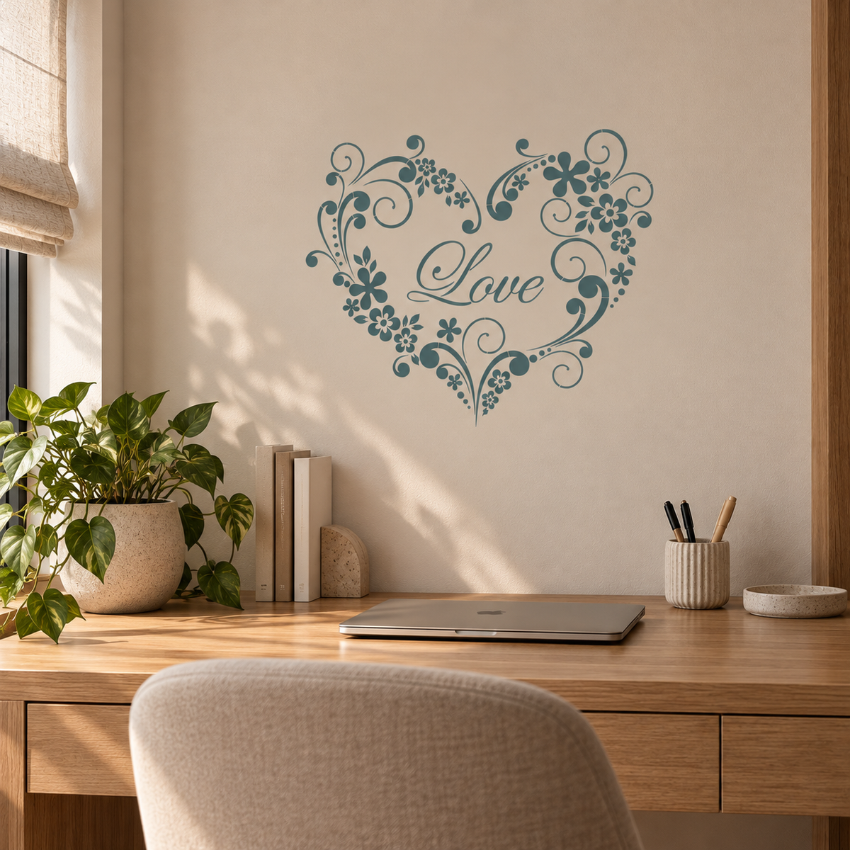 Love Heart Floral Stencil in dusty blue on a beige wall above a wooden desk in a bright home office.