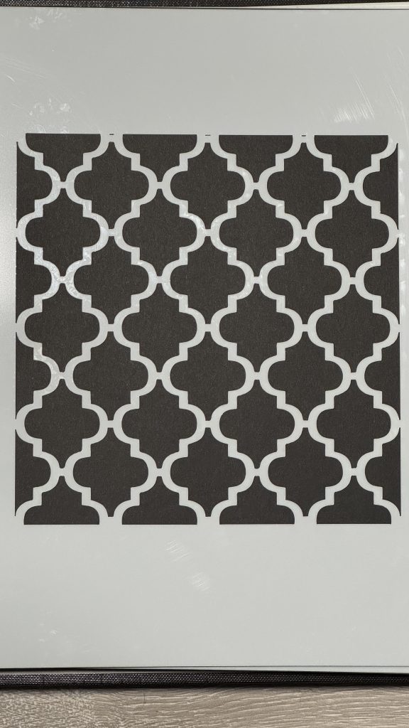 Repeating Moroccan-style geometric stencil pattern sheet with interlocking quatrefoil design in black and white.