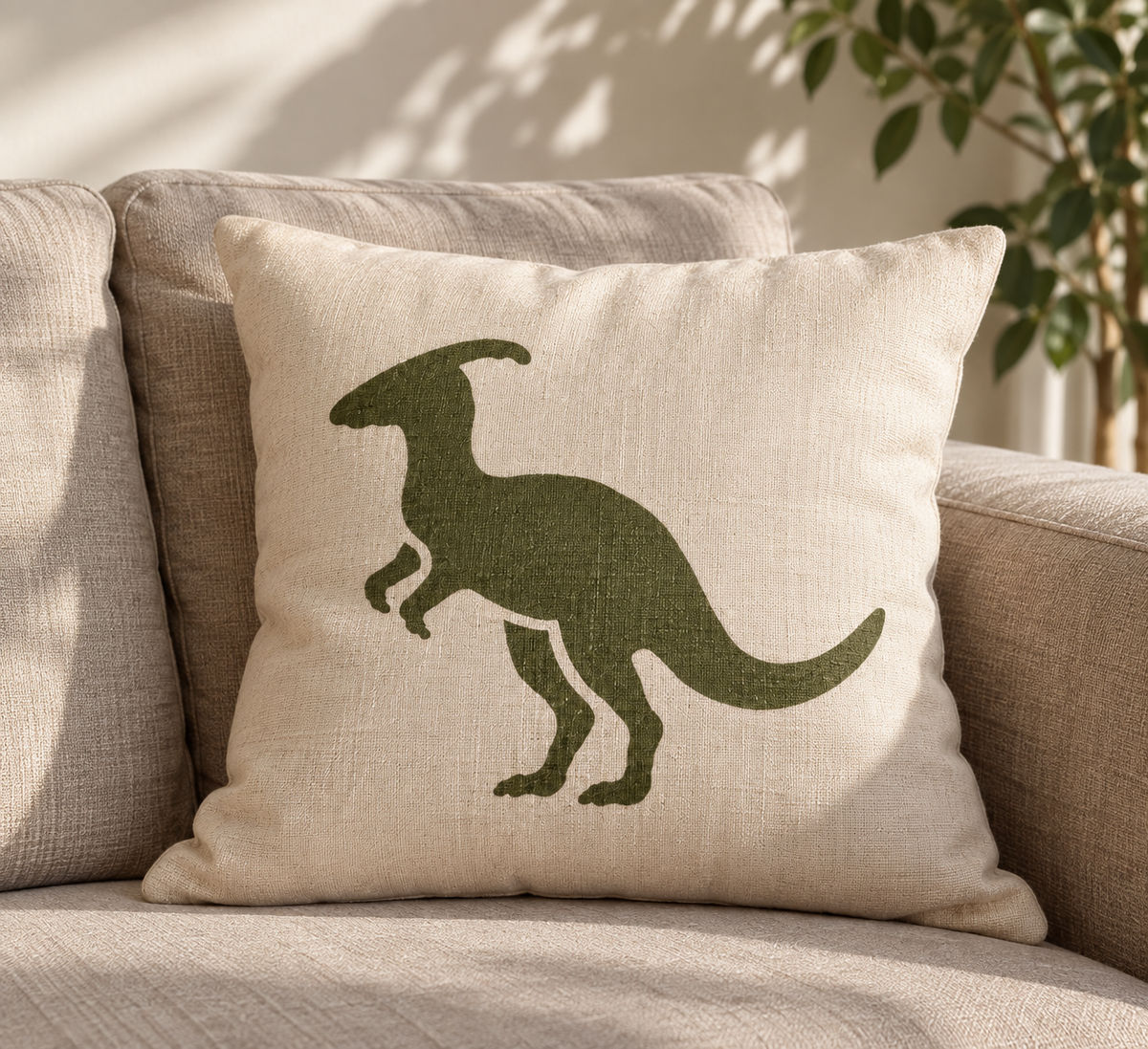 Green Parasaurolophus dinosaur stencil painted on a beige fabric cushion, showing a creative DIY stencil idea for pillows, textiles and home decor.