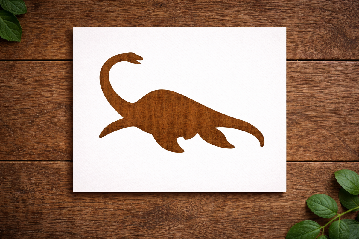 Reusable Plesiosaurus dinosaur stencil made from 300 micron Mylar plastic placed on wooden background.