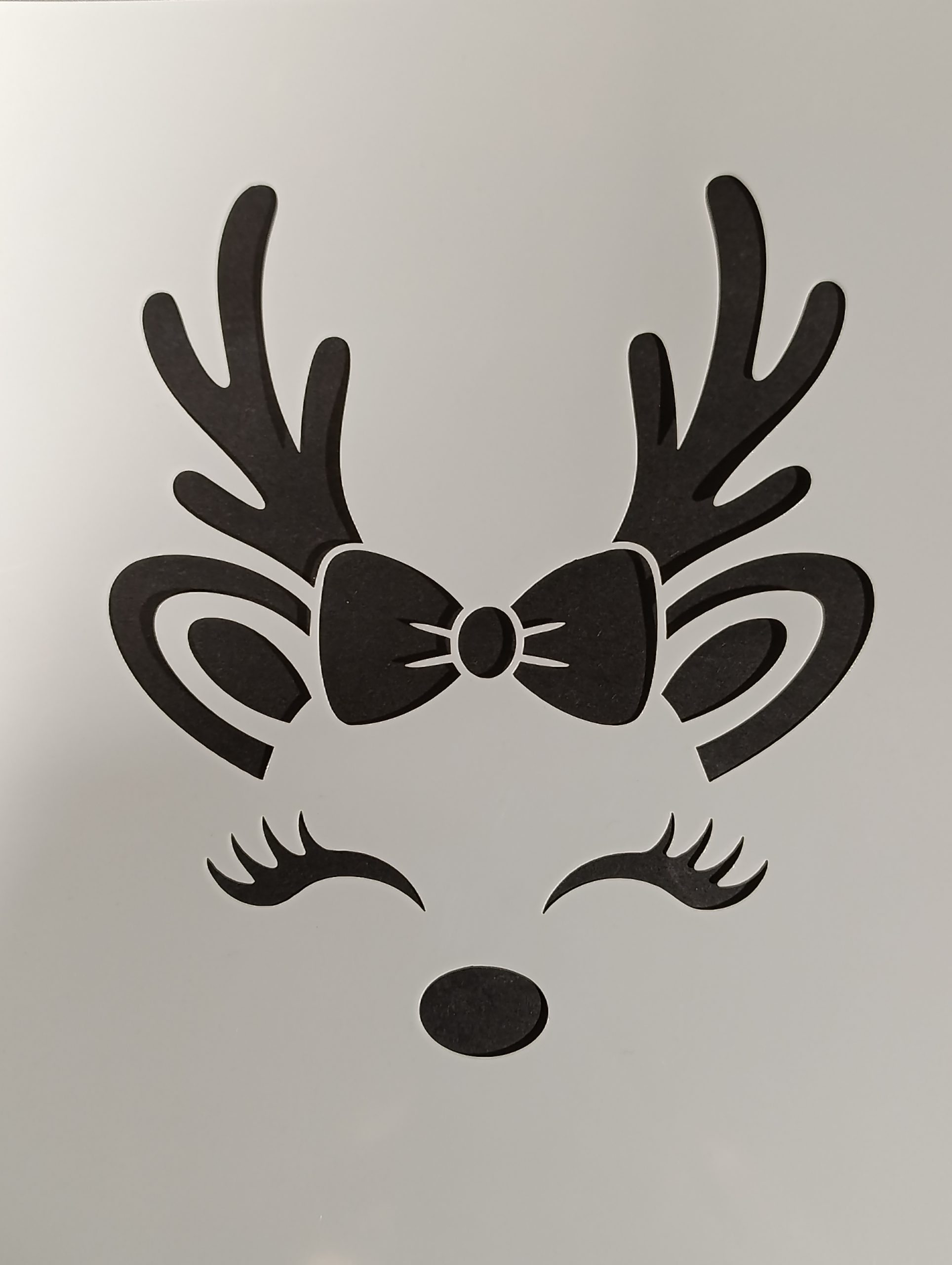Cute reindeer face Christmas stencil with bow and eyelashes