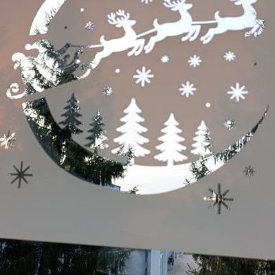 Santa’s sleigh window stencil applied on glass, creating a festive holiday silhouette decoration.