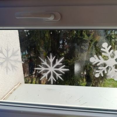 Snowflake stencils applied on a window with a frosted effect