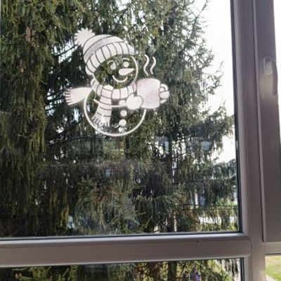 christmas snowman and snowflake stencils displayed on school windows