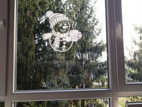 christmas snowman and snowflake stencils displayed on school windows