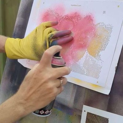 Spray painting a halftone stencil with controlled layers to achieve clean dot or line pattern shading