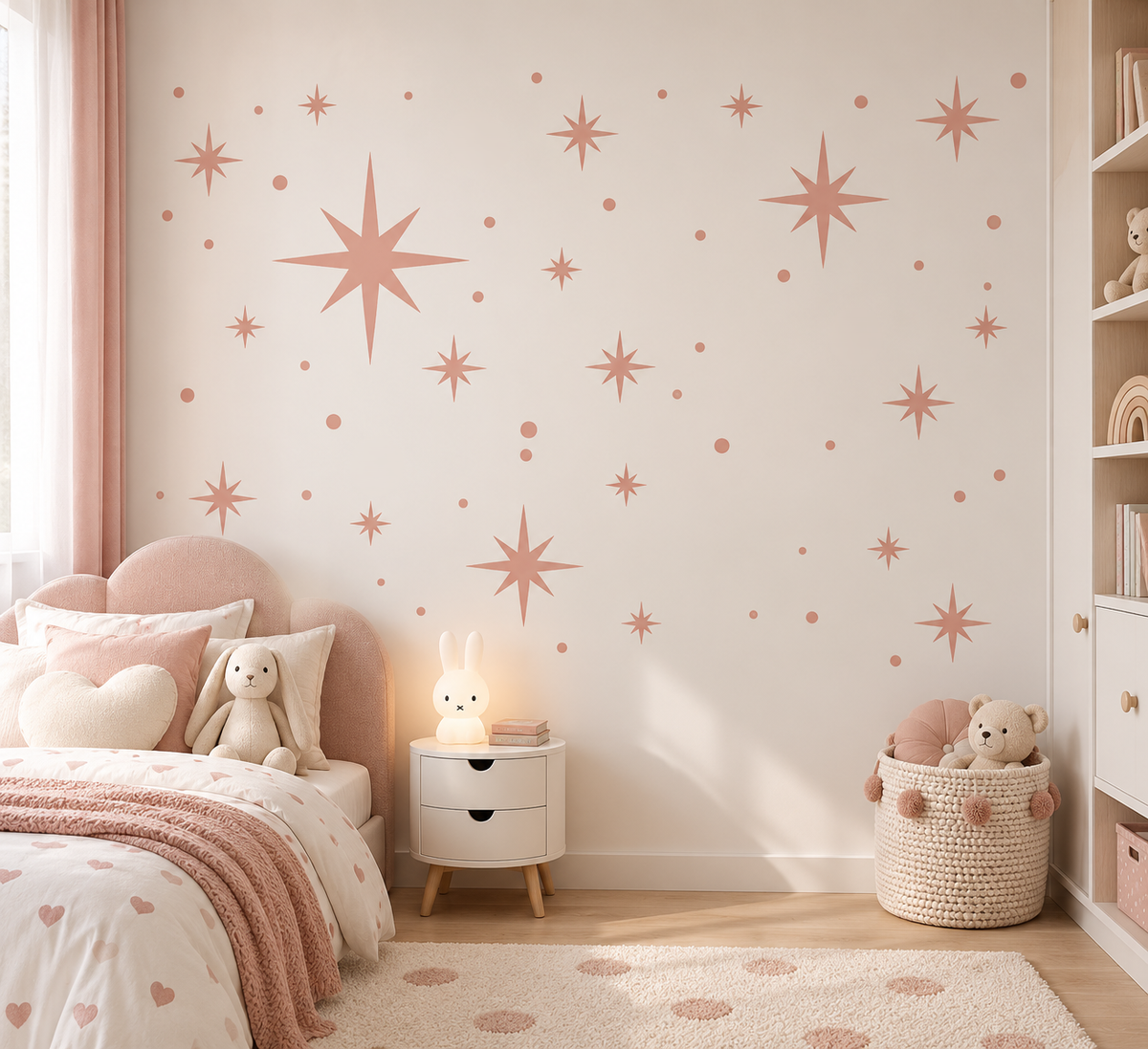 Blush pink star wall stencil with scattered celestial stars and dots in a soft modern girls’ bedroom.