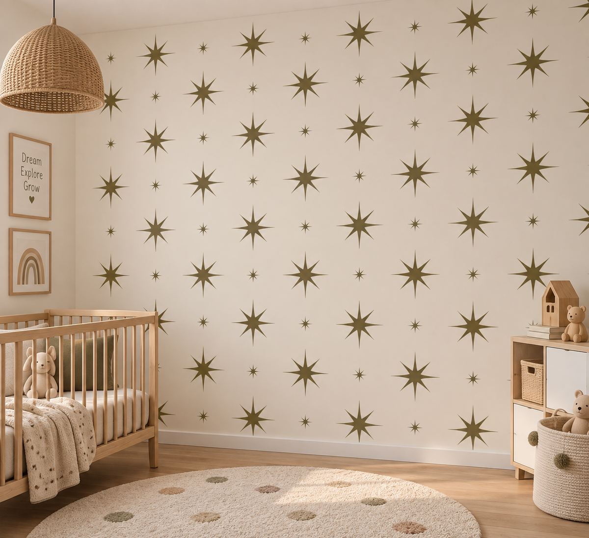 Olive green starburst wall stencils in large and small sizes painted across a neutral nursery wall, creating a modern celestial pattern.