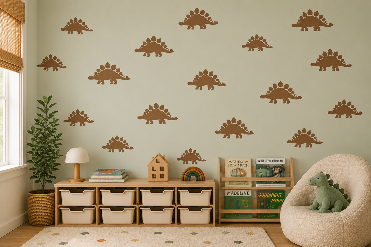 Brown stegosaurus dinosaur stencil pattern on a soft sage green wall in a cozy kids room with toy storage, books, and neutral decor.