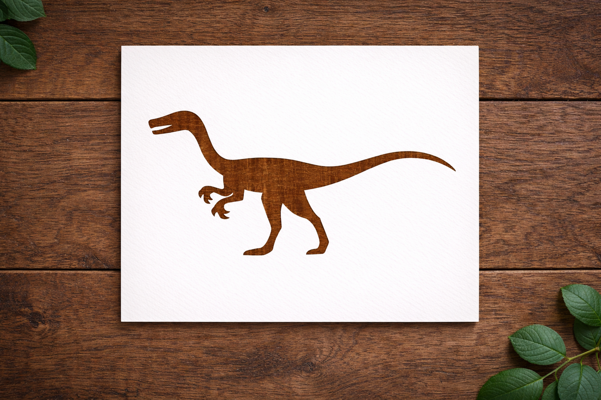 Reusable Velociraptor dinosaur stencil made from 300 micron Mylar plastic placed on wooden background.