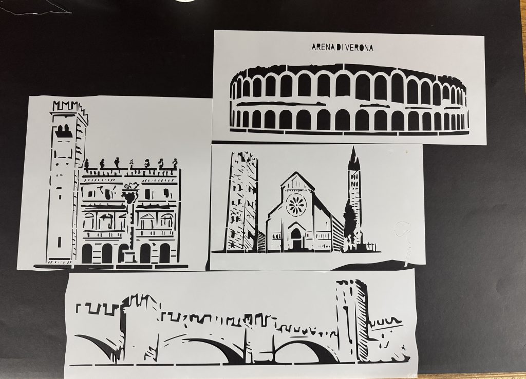 Set of architectural stencils featuring Verona landmarks including Arena di Verona and historic buildings, displayed on a dark surface.