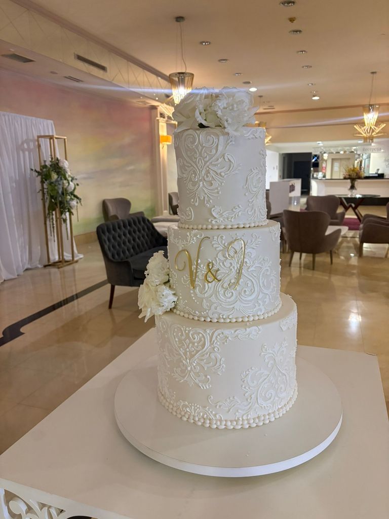 Elegant wedding cake featuring an ornamental Damask Stencil design with delicate white-on-white details